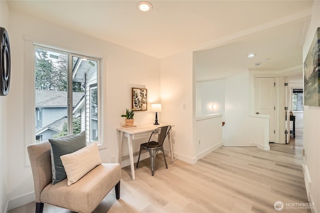 living area with recessed lighting, baseboards, and light wood finished floors