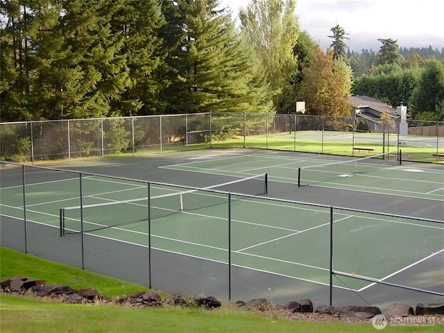 view of sport court featuring fence