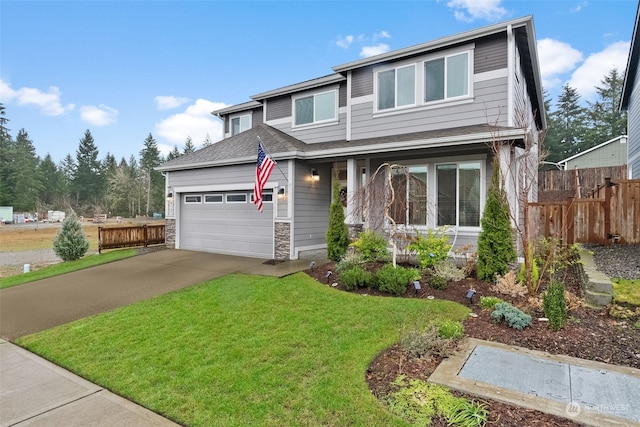 view of front of property with a garage and a front yard