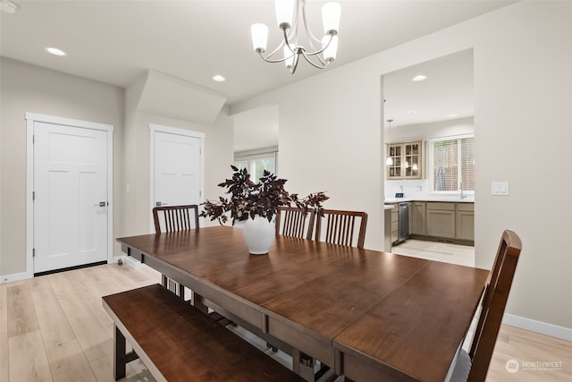 dining area with a chandelier and light hardwood / wood-style floors