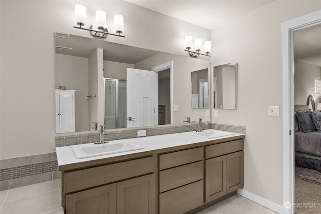 bathroom featuring vanity, an enclosed shower, and tile patterned floors