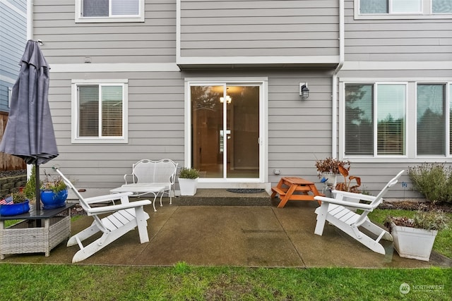 view of exterior entry featuring a patio area