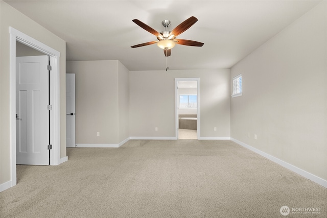 empty room featuring baseboards, ceiling fan, and light colored carpet