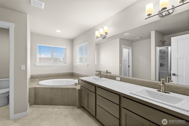 bathroom featuring toilet, a sink, a bath, visible vents, and a shower