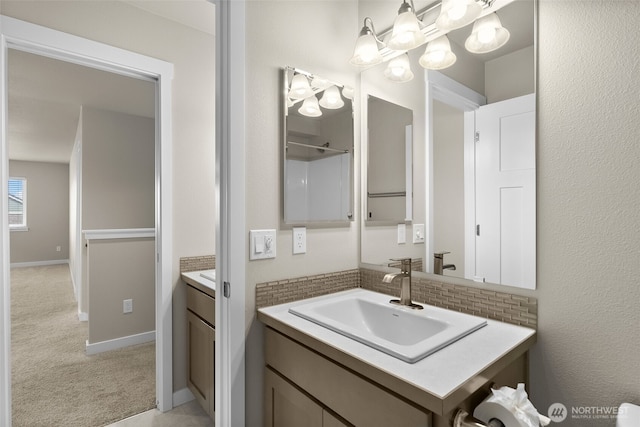 bathroom with a notable chandelier and vanity