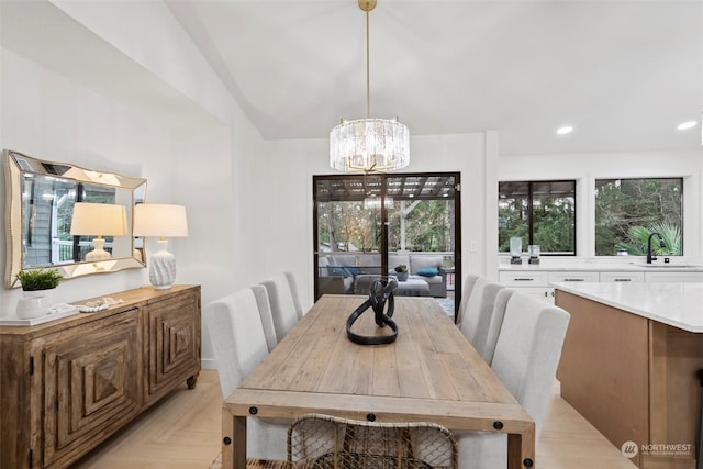 dining area with a notable chandelier, light parquet flooring, sink, and a wealth of natural light