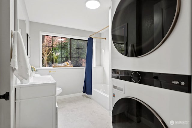 clothes washing area with stacked washer and dryer