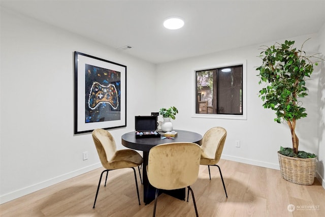 dining space featuring light wood-type flooring