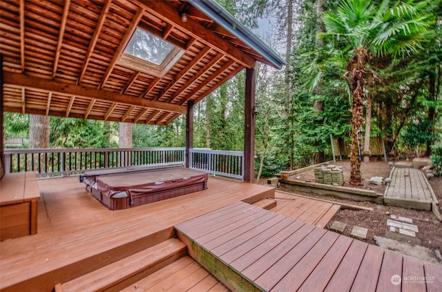 wooden terrace featuring a pergola and a covered hot tub