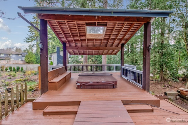 deck with a pergola and a covered hot tub