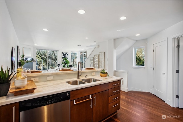 kitchen with dark hardwood / wood-style flooring, dishwasher, and sink