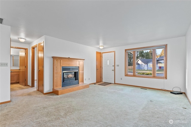 unfurnished living room featuring light carpet