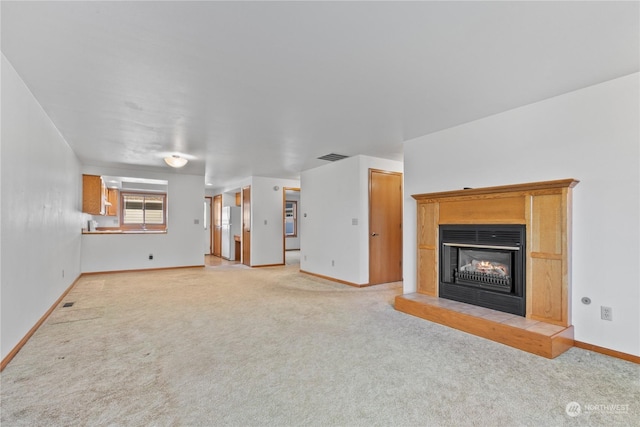 unfurnished living room with light colored carpet