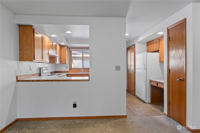 kitchen with sink, white appliances, and light colored carpet