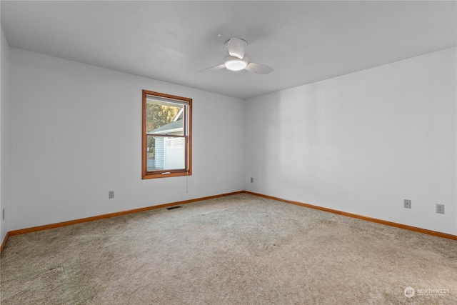 empty room featuring carpet floors and ceiling fan