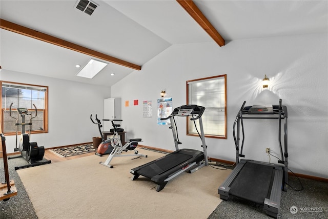 exercise room featuring carpet flooring and vaulted ceiling with skylight