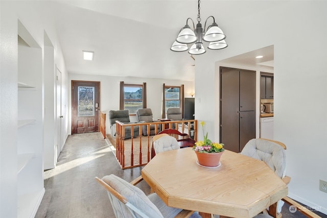 dining area with a notable chandelier, light wood-style flooring, and baseboards