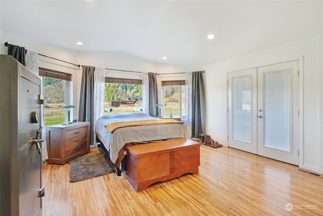 bedroom with visible vents, light wood finished floors, lofted ceiling, recessed lighting, and french doors