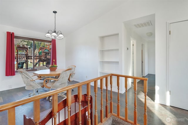 dining area featuring visible vents, an inviting chandelier, baseboards, and lofted ceiling