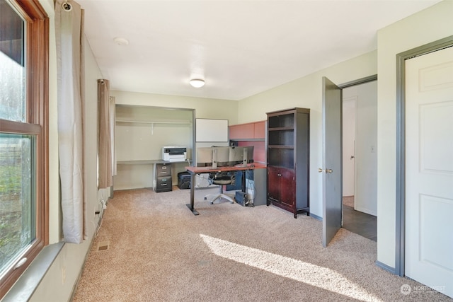 carpeted office with baseboards and visible vents