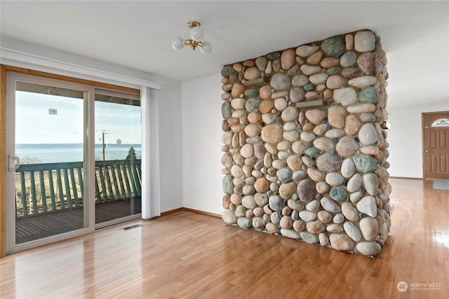 550 SW Waterloo Ave, Oak Harbor, WA 98277 - spare room featuring light hardwood / wood-style flooring and a water view