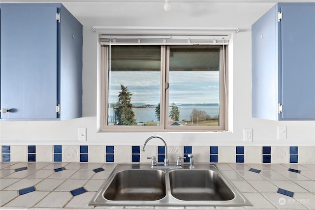 550 SW Waterloo Ave, Oak Harbor, WA 98277 - kitchen with sink, tile countertops, and blue cabinetry