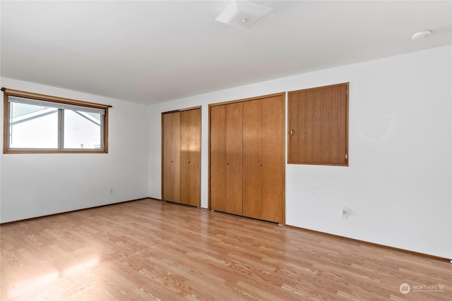 550 SW Waterloo Ave, Oak Harbor, WA 98277 - unfurnished bedroom featuring multiple closets and light wood-type flooring