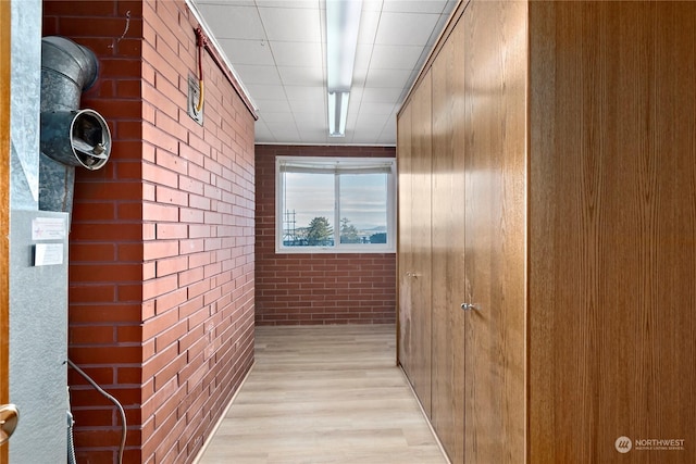 550 SW Waterloo Ave, Oak Harbor, WA 98277 - hallway with brick wall and light wood-type flooring