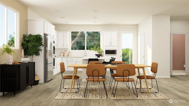 kitchen featuring built in microwave, stainless steel fridge with ice dispenser, light hardwood / wood-style flooring, decorative backsplash, and white cabinets