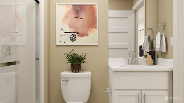 bathroom with vanity, toilet, and an enclosed shower