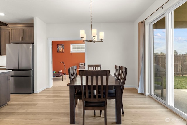 dining area with a notable chandelier and light wood-type flooring