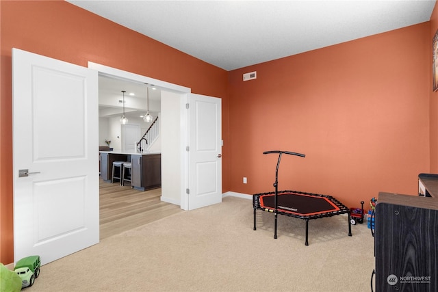 interior space featuring sink and light carpet