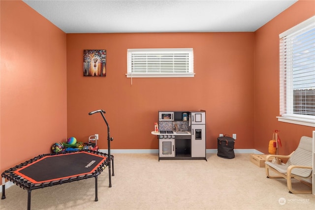 game room with plenty of natural light and carpet flooring