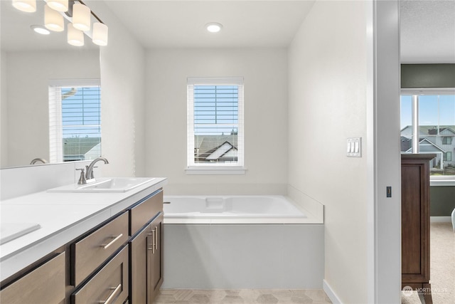 bathroom with vanity and a bath