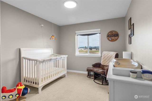 carpeted bedroom with a nursery area