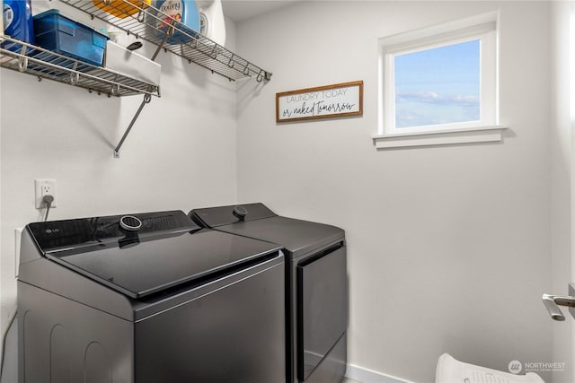 clothes washing area featuring washer and dryer