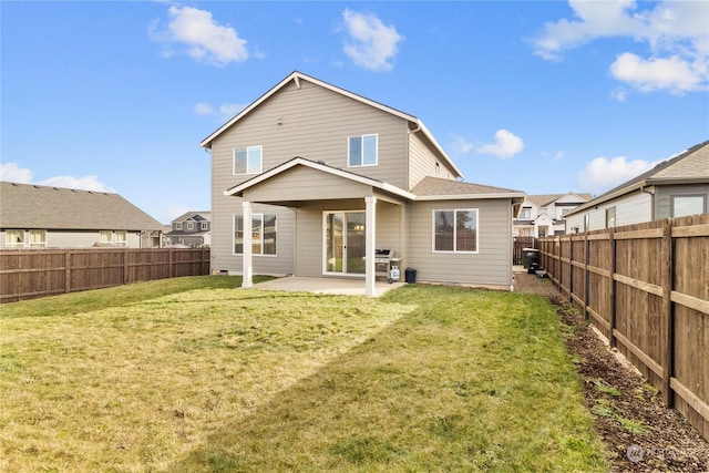 rear view of property featuring a yard and a patio area