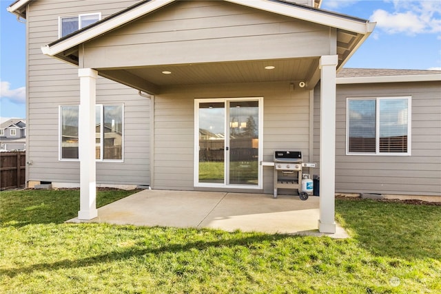 rear view of house with a patio and a lawn