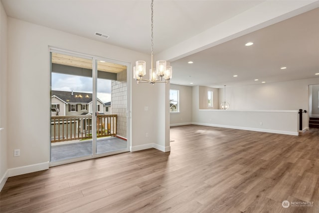 interior space with hardwood / wood-style flooring and an inviting chandelier