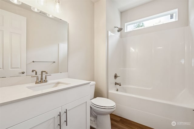 full bathroom featuring toilet, wood-type flooring, vanity, and shower / bathing tub combination