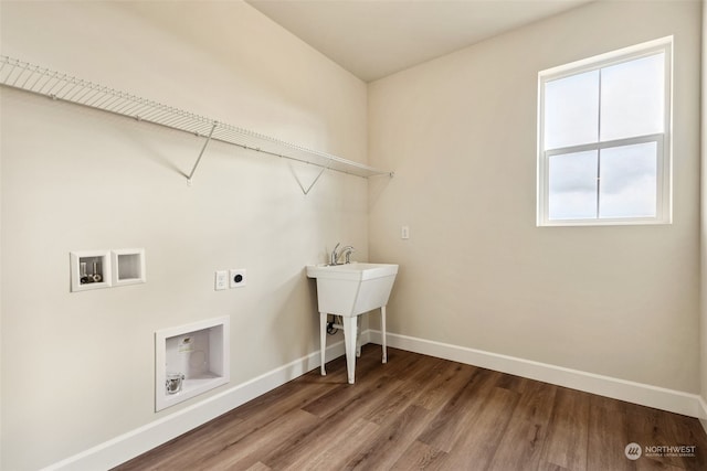 washroom with sink, hardwood / wood-style floors, hookup for a washing machine, and hookup for an electric dryer