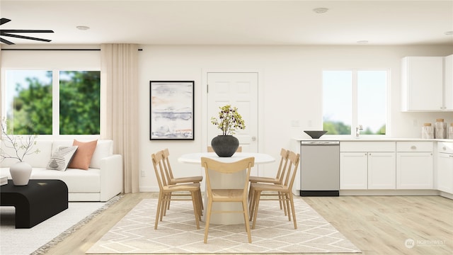 dining area with sink, ceiling fan, and light hardwood / wood-style flooring