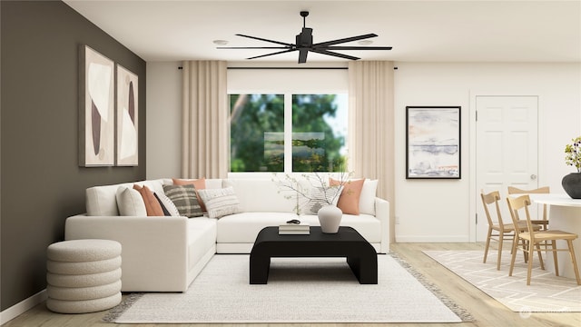 living room with ceiling fan and light hardwood / wood-style flooring