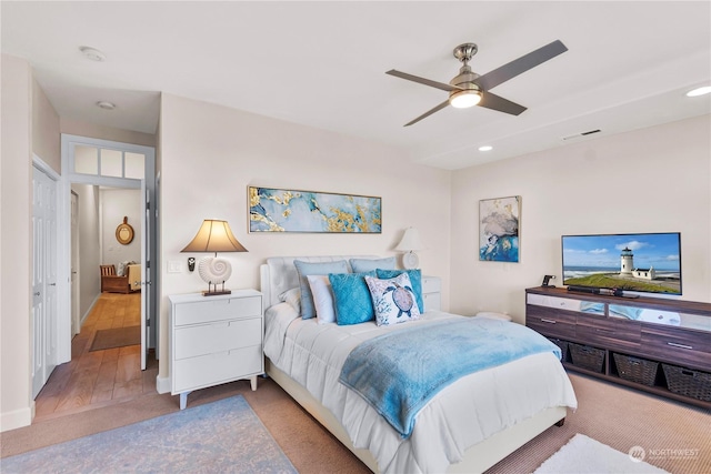 bedroom with hardwood / wood-style floors and ceiling fan