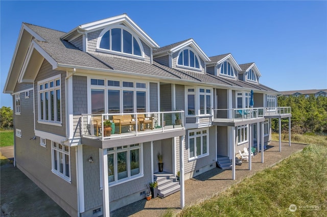 back of property with a balcony