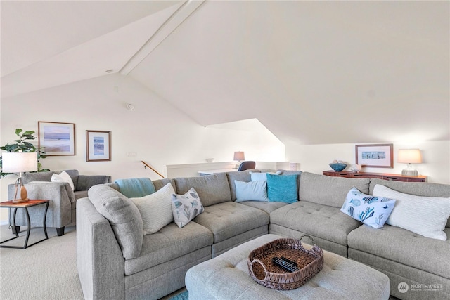 carpeted living room with vaulted ceiling with beams