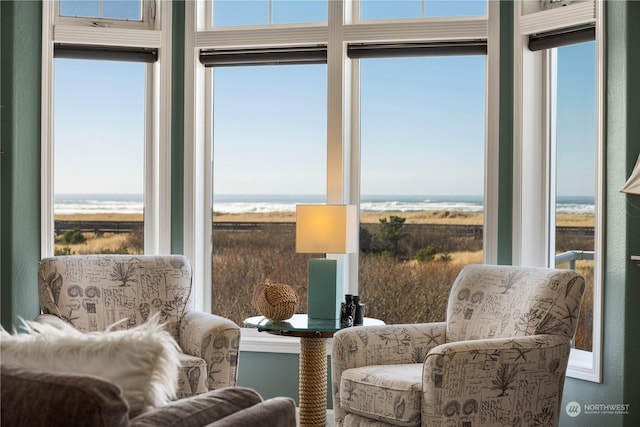 sitting room with plenty of natural light and a water view