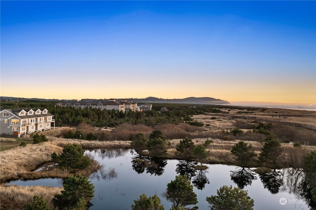 aerial view at dusk with a water view