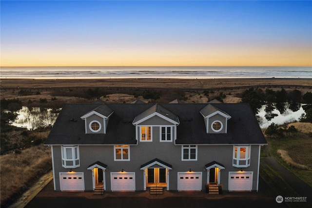 view of front of home featuring a water view and a view of the beach