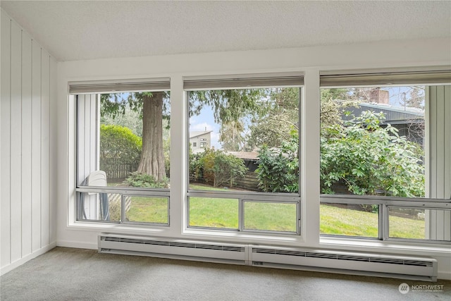 interior space with a baseboard radiator, a textured ceiling, and carpet flooring